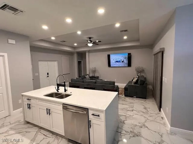 kitchen with visible vents, white cabinets, dishwasher, open floor plan, and a sink