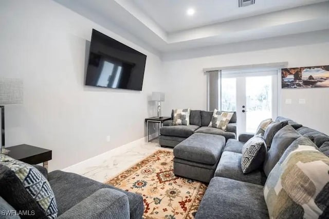 living room with marble finish floor, recessed lighting, a raised ceiling, visible vents, and baseboards