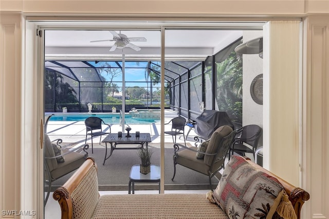 view of patio featuring glass enclosure, a pool with connected hot tub, and grilling area