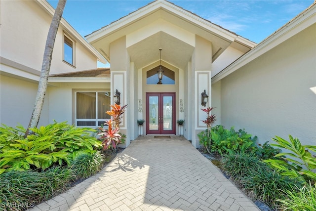 property entrance with french doors and stucco siding