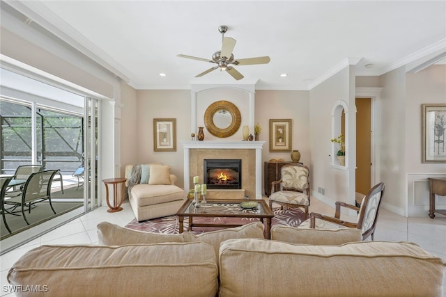 living area with ornamental molding, light tile patterned flooring, a glass covered fireplace, and baseboards