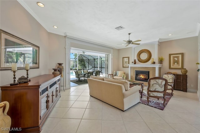 living area with light tile patterned flooring, recessed lighting, a fireplace, visible vents, and crown molding