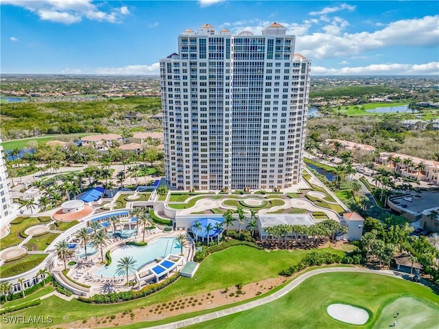 drone / aerial view with a water view, a city view, and golf course view