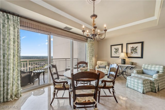 dining space featuring a chandelier, a tray ceiling, ornamental molding, and visible vents