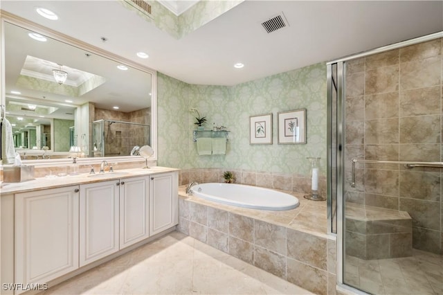 full bathroom with visible vents, vanity, a bath, a tray ceiling, and a stall shower