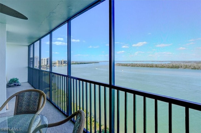 unfurnished sunroom with a water view