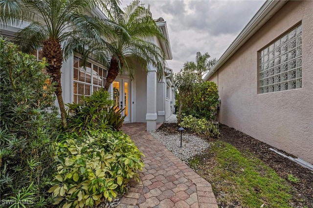 property entrance with stucco siding