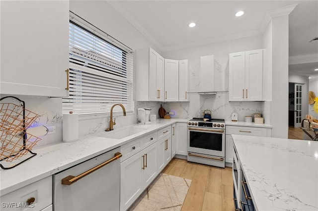 kitchen with dishwasher, crown molding, wall chimney range hood, white cabinetry, and high end white range