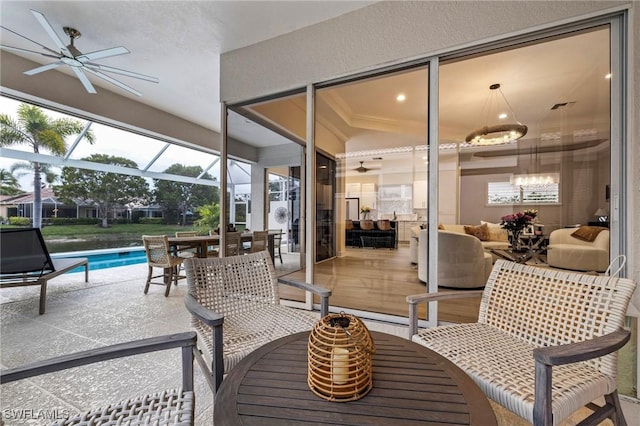 view of patio / terrace featuring glass enclosure, ceiling fan, outdoor dining area, and an outdoor pool