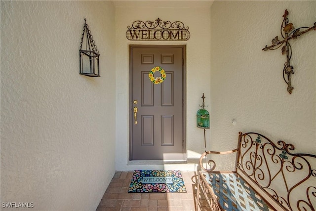 doorway to property with stucco siding