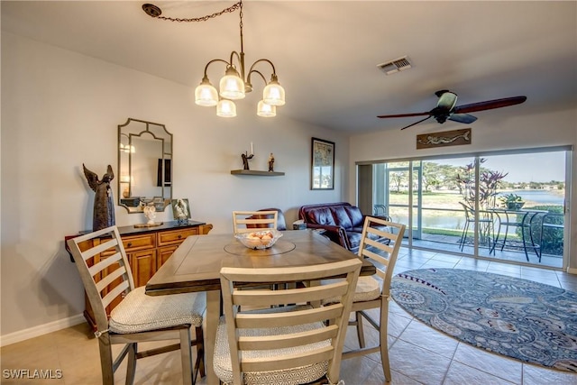 dining room featuring ceiling fan with notable chandelier, light tile patterned floors, visible vents, and baseboards