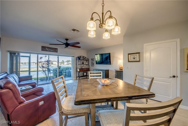 dining space with light tile patterned floors, visible vents, and ceiling fan with notable chandelier