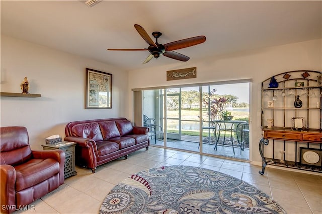 living area featuring light tile patterned floors and ceiling fan