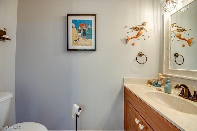 bathroom with vanity and toilet