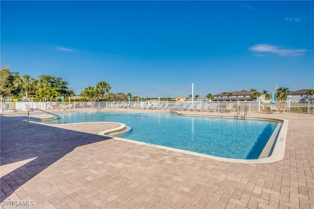 community pool featuring fence and a patio