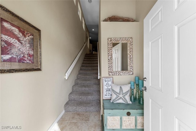 stairs featuring baseboards and tile patterned floors