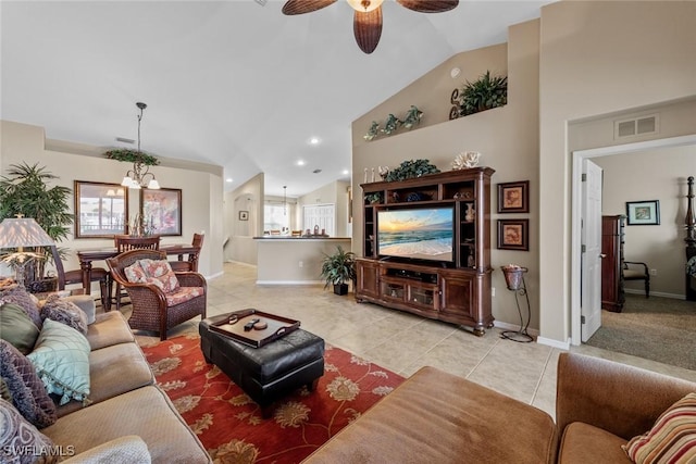 living area featuring light tile patterned floors, baseboards, visible vents, and ceiling fan with notable chandelier