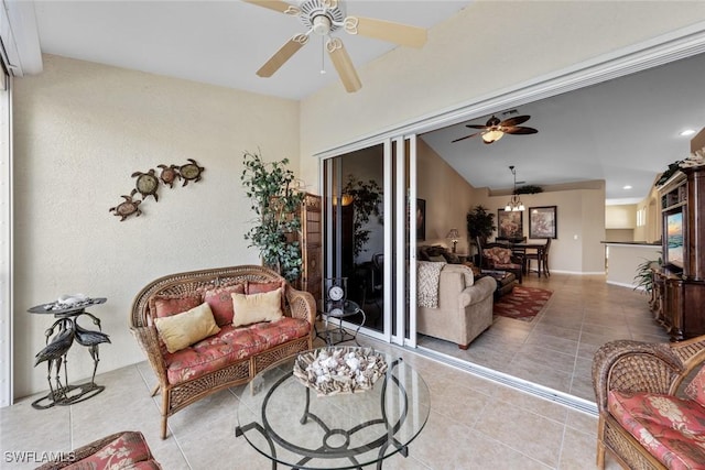 interior space featuring light tile patterned floors, ceiling fan, and lofted ceiling