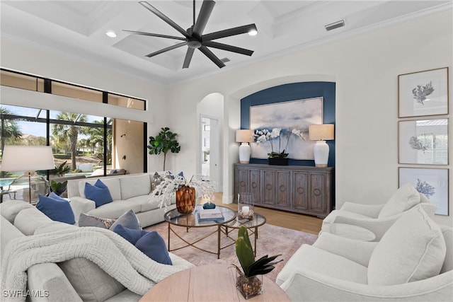 living area featuring visible vents, coffered ceiling, crown molding, and beamed ceiling