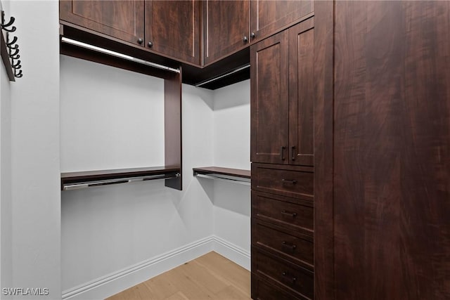 walk in closet featuring light wood finished floors