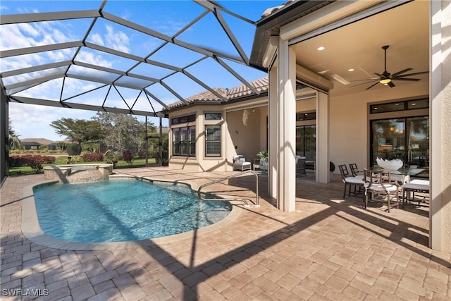 view of pool featuring a pool with connected hot tub, a patio area, and ceiling fan