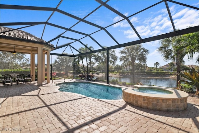 view of pool featuring a pool with connected hot tub, a lanai, a patio area, and a water view