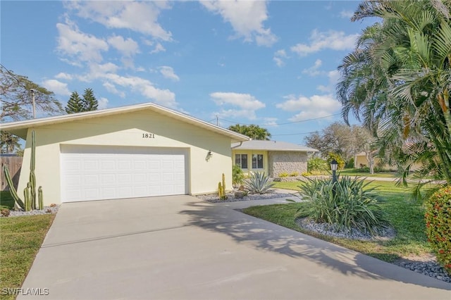 single story home featuring a garage, concrete driveway, and stucco siding