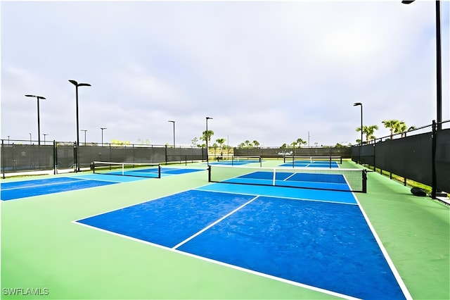 view of tennis court with fence