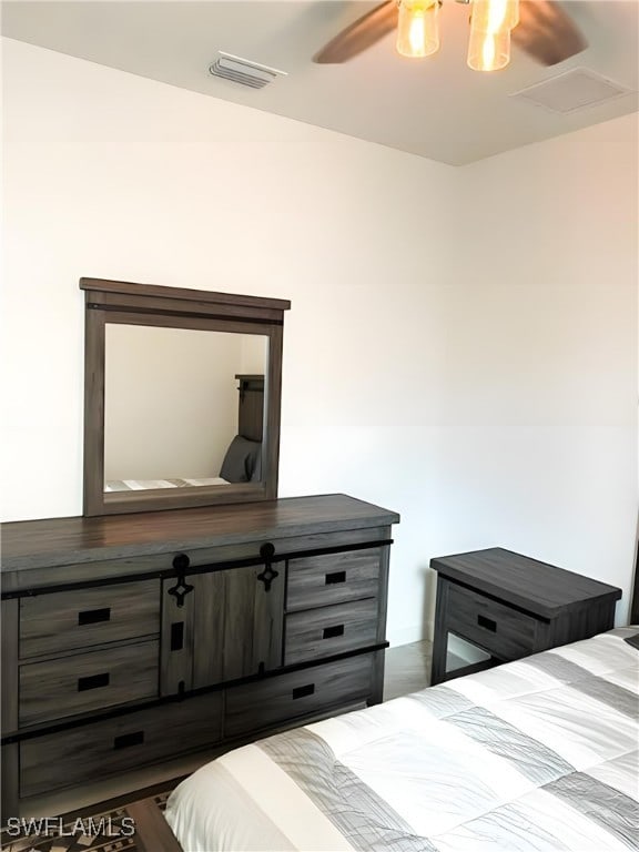 bedroom featuring a ceiling fan and visible vents