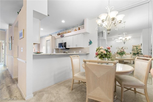 dining room featuring a chandelier, recessed lighting, and baseboards