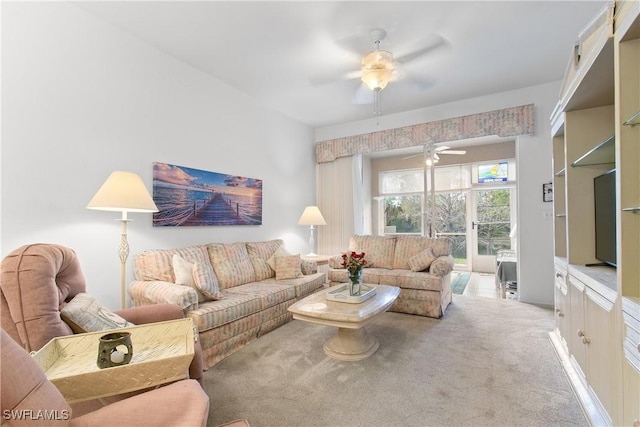 carpeted living area with ceiling fan