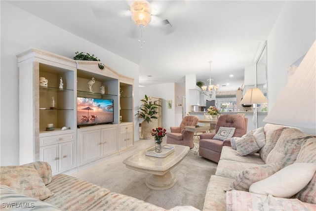 living area with a chandelier and light colored carpet