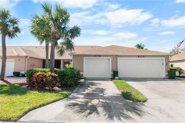 ranch-style home with driveway, an attached garage, and stucco siding