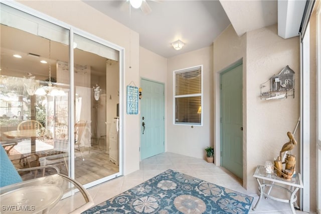 bathroom featuring ceiling fan and tile patterned flooring