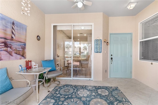 entrance to property with a ceiling fan and a patio