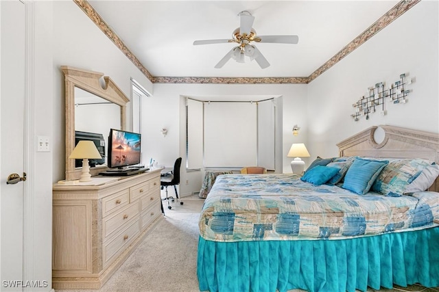 bedroom with a ceiling fan and light colored carpet