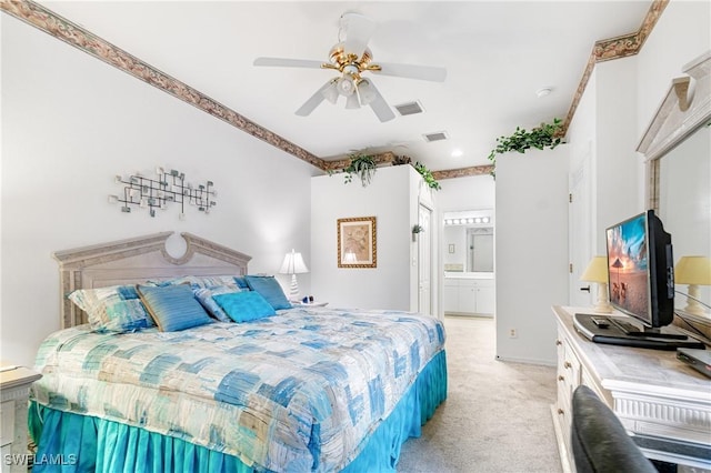 bedroom with a ceiling fan, light colored carpet, connected bathroom, and visible vents