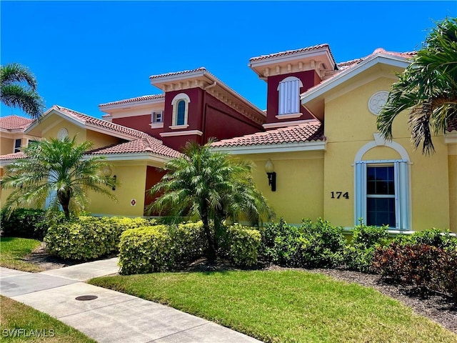 mediterranean / spanish-style home featuring a tile roof and stucco siding