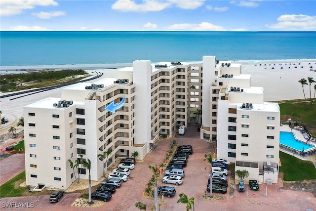 bird's eye view featuring a water view and a beach view