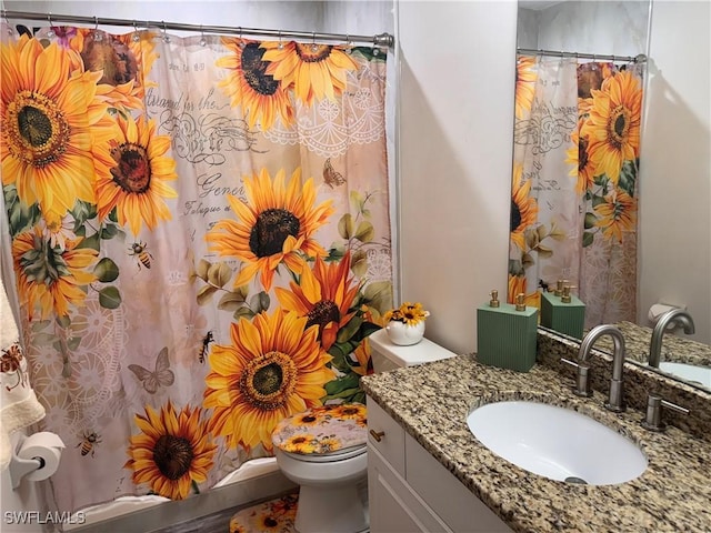 bathroom featuring toilet and vanity