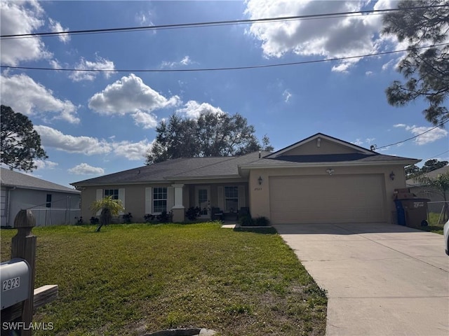 ranch-style house with driveway, stucco siding, an attached garage, fence, and a front yard