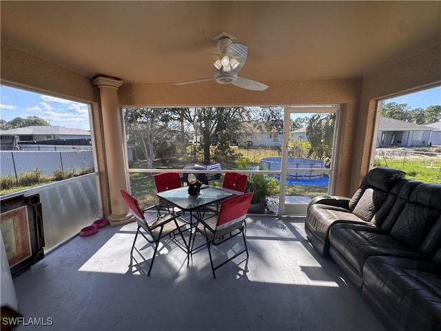 sunroom featuring a ceiling fan and a healthy amount of sunlight