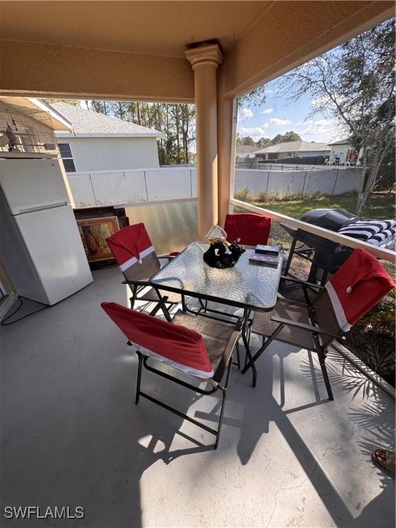 view of patio with fence and outdoor dining area