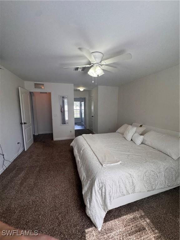 bedroom featuring a ceiling fan, dark colored carpet, visible vents, and baseboards