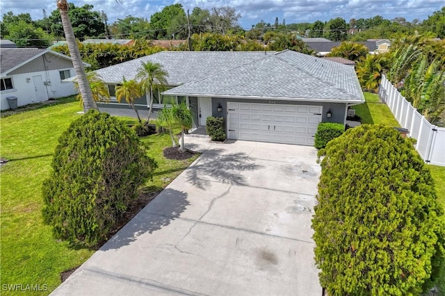 2143 Tropic Ave, Fort Myers, FL 33905 - ranch-style house with a front lawn, driveway, fence, a garage, and a shingled roof