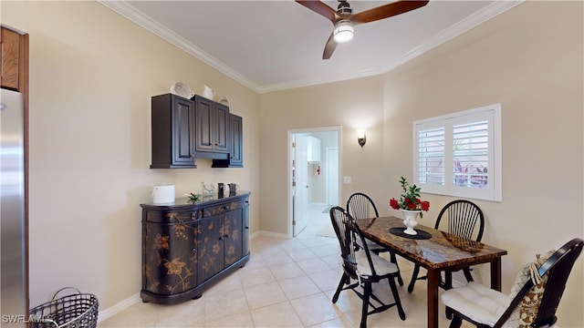 dining space featuring ornamental molding, light tile patterned floors, baseboards, and a ceiling fan