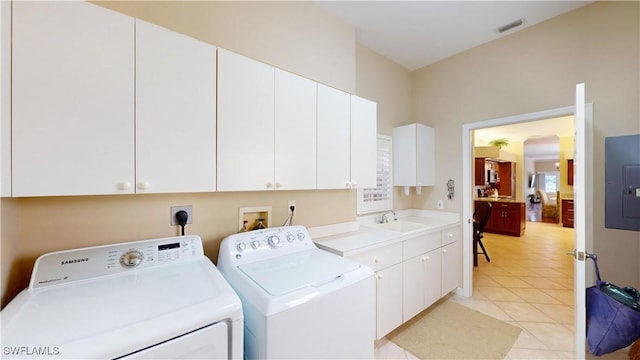 washroom featuring cabinet space, electric panel, visible vents, washer and dryer, and a sink