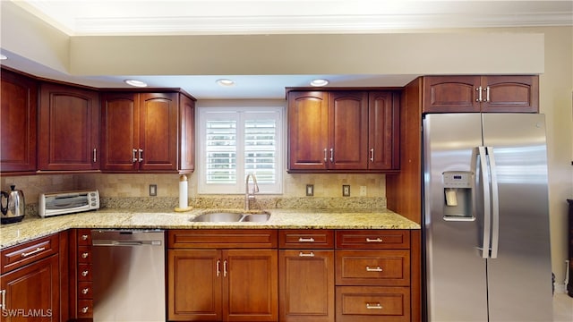 kitchen featuring decorative backsplash, light stone counters, ornamental molding, stainless steel appliances, and a sink