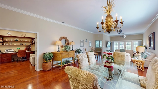 dining room with french doors, a notable chandelier, visible vents, ornamental molding, and wood finished floors