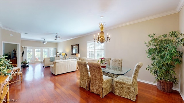 dining area featuring ornamental molding, plenty of natural light, and wood finished floors